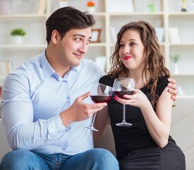 Young pair drinking wine in romantic concept