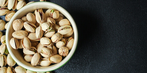 pistachios tasty nuts snack Menu concept serving size. food background top view copy space for text organic healthy eating  
