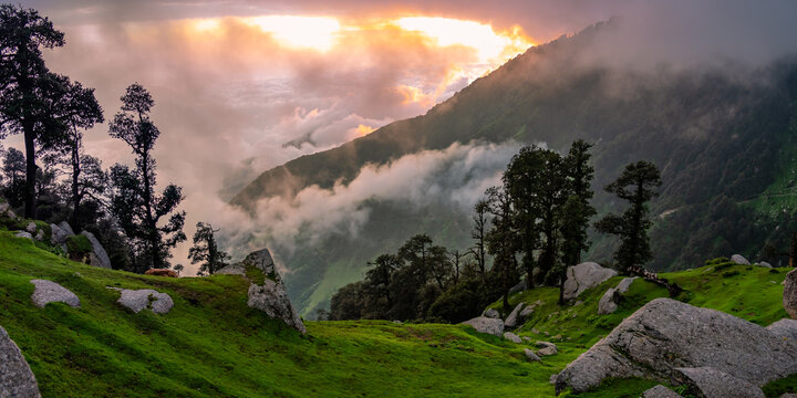 Mesmerizing view of cloudy red sunset sky background during sunset enroute to Triund trekking trail from Mcleodganj, Dhramshala, Himachal Pradesh, India.
