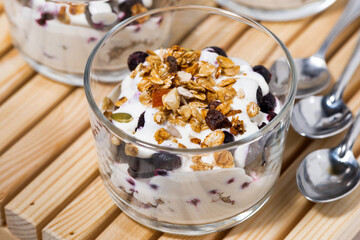 healthy dessert with blueberries, yogurt and muesli, top view closeup