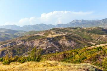 Serpentine mountain road on sunny day. View of the Caucasus Mountains in a sunny day