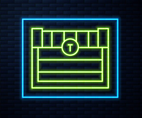 Glowing neon line Antique treasure chest icon isolated on brick wall background. Vintage wooden chest with golden coin. Vector.