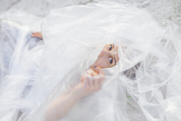 Portrait of beautiful woman in polyethylene wrap. Ecology concept. 