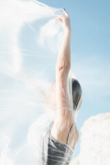 Portrait of beautiful woman in polyethylene wrap. Ecology concept. 