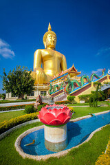 Beautiful of Large golden sitting Buddha statue with background of blue sky at Wat Muang  temple ,Ang Thaong,Thailand