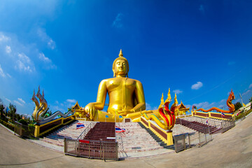 Beautiful of Large golden sitting Buddha statue with background of blue sky at Wat Muang  temple ,Ang Thaong,Thailand