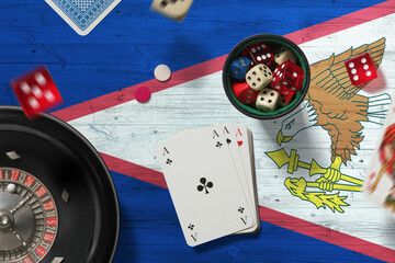 American Samoa casino theme. Aces in poker game, cards and chips on red table with national flag...