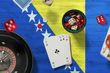 Bosnia Herzegovina casino theme. Aces in poker game, cards and chips on red table with national flag background. Gambling and betting.