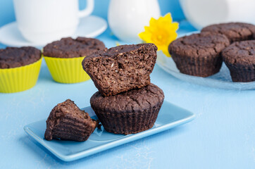 Chocolate muffins on a blue background close-up. Homemade Baking