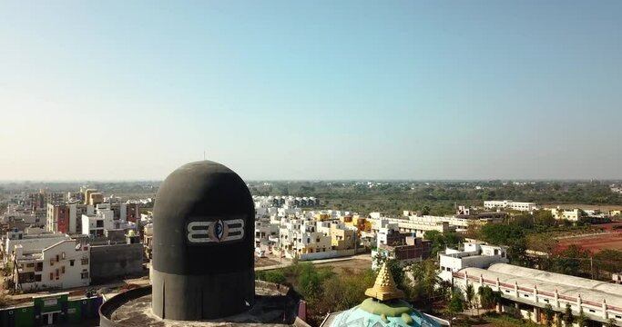 Scenic View Of A Shivling, Symbol Of A Deity, Situated On A Rooftop In Chhattisgarh, India - ascending drone shot