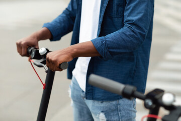 Guy having pleasant ride on electric kick scooter © Prostock-studio