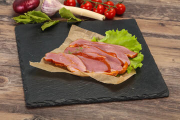 Sliced smoked duck breast served salad