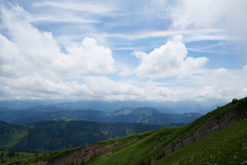 rainbow in the clouds over a mountain landscape in the bavarian alps