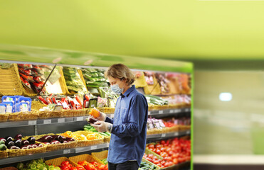 Supermarket shopping, face mask and gloves,man buying vegetables at the market	