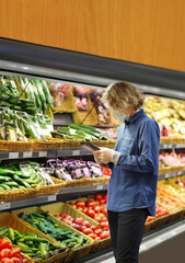 Supermarket shopping, face mask and gloves,man buying vegetables at the market	