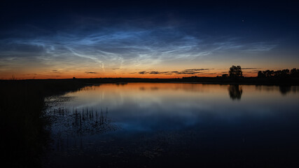 Fototapeta na wymiar Ural landscape at night on the river with silvery clouds, Russia, Ural Sverdlovsk region