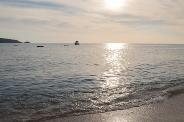 Fototapeta premium Beach in Thailand with boats and hills in the background. Phuket