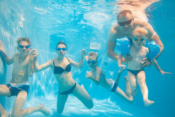 family  in swimming pool