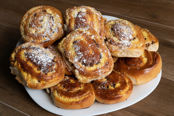 Patties with cottage cheese and raisins folded in a pile on a plate. Cheesecake, pie with cottage cheese.