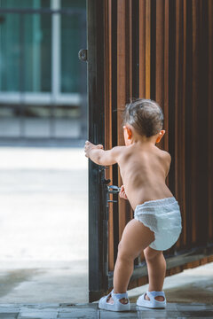 Selective focus, Asian baby boy hands kid try to open or close door.Child want to escape to play,Security and Safety Concept.