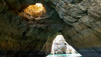 Albufeira, Portugal - July 11, 2020: A group of tourist in a boat visiting the caves of Benagil