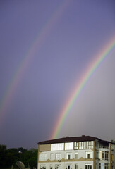 Double rainbow in the sky above the city