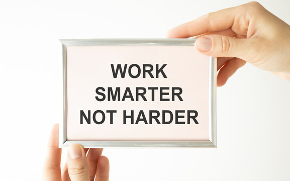 Work Smarter Not Harder Concept. Closeup retro style image business woman hands holding card with motivational message phrase text written on it isolated grey office wall background