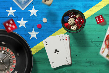 Solomon Islands casino theme. Aces in poker game, cards and chips on red table with national flag...