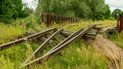 an old and broken overgrown railway