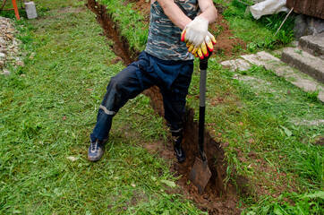 worker digs a hole