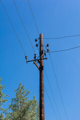 old wooden pole with electric wires in the countryside