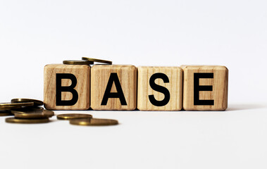 wooden cubes and BASE, coins, the concept of taxation, increase taxes and fees