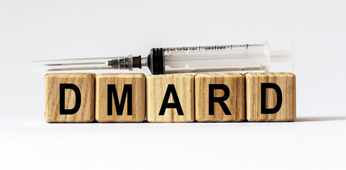 Text DMARD made from wooden cubes. White background