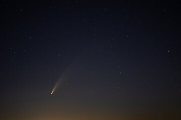 View of the C/2020 F3 (NEOWISE) comet with tail above Europe. Starry night sky.  Photo taken on...