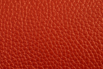 The texture of genuine leather. The texture of bovine skin. Macro photo. The skin is bovine. Relief skin texture. The surface of the product is made of genuine calf leather. Red abstract texture backg