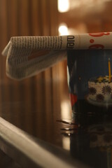 news paper on a tea cup kept on a veranda