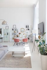 Cozy luxury modern interior design of a studio apartment in extra white colors with fashionable expensive furniture in a minimalist style. white tiled floor, kitchen, relaxation area and workplace