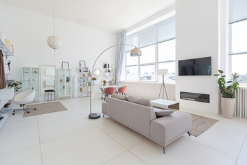 Fototapeta na wymiar Cozy luxury modern interior design of a studio apartment in extra white colors with fashionable expensive furniture in a minimalist style. white tiled floor, kitchen, relaxation area and workplace