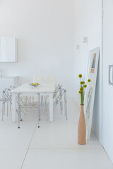 Cozy luxury modern interior design of a studio apartment in extra white colors with fashionable expensive furniture in a minimalist style. white tiled floor, kitchen, relaxation area and workplace
