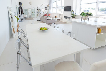 Cozy luxury modern interior design of a studio apartment in extra white colors with fashionable expensive furniture in a minimalist style. white tiled floor, kitchen, relaxation area and workplace