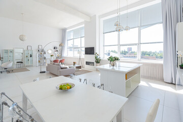Plakat Cozy luxury modern interior design of a studio apartment in extra white colors with fashionable expensive furniture in a minimalist style. white tiled floor, kitchen, relaxation area and workplace