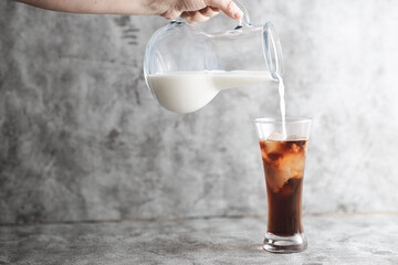 Minimalist looking milk is being filled to ice coffee, beautiful and fantastic shapes occurs with copy space