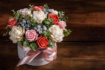 Bouquet of beautiful bright rose flowers in a gift cylindrical cardboard box