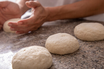 woman hands kneading pizza close-up