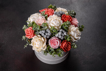 Fototapeta na wymiar Bouquet of beautiful bright rose flowers in a gift cylindrical cardboard box