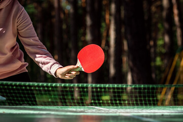 Ping pong rackets in hand close-up. The concept of a healthy lifestyle, sports games. Copy space, soft focus.