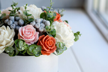 Bouquet of beautiful bright rose flowers in a gift cylindrical cardboard box