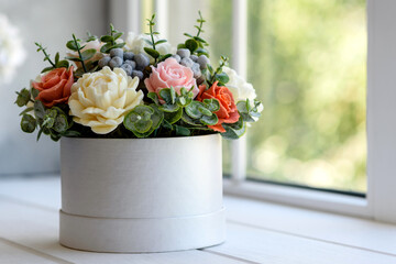 Bouquet of beautiful bright rose flowers in a gift cylindrical cardboard box