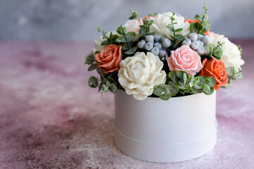 Bouquet of beautiful bright rose flowers in a gift cylindrical cardboard box