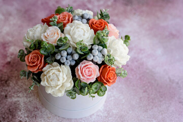 Bouquet of beautiful bright rose flowers in a gift cylindrical cardboard box